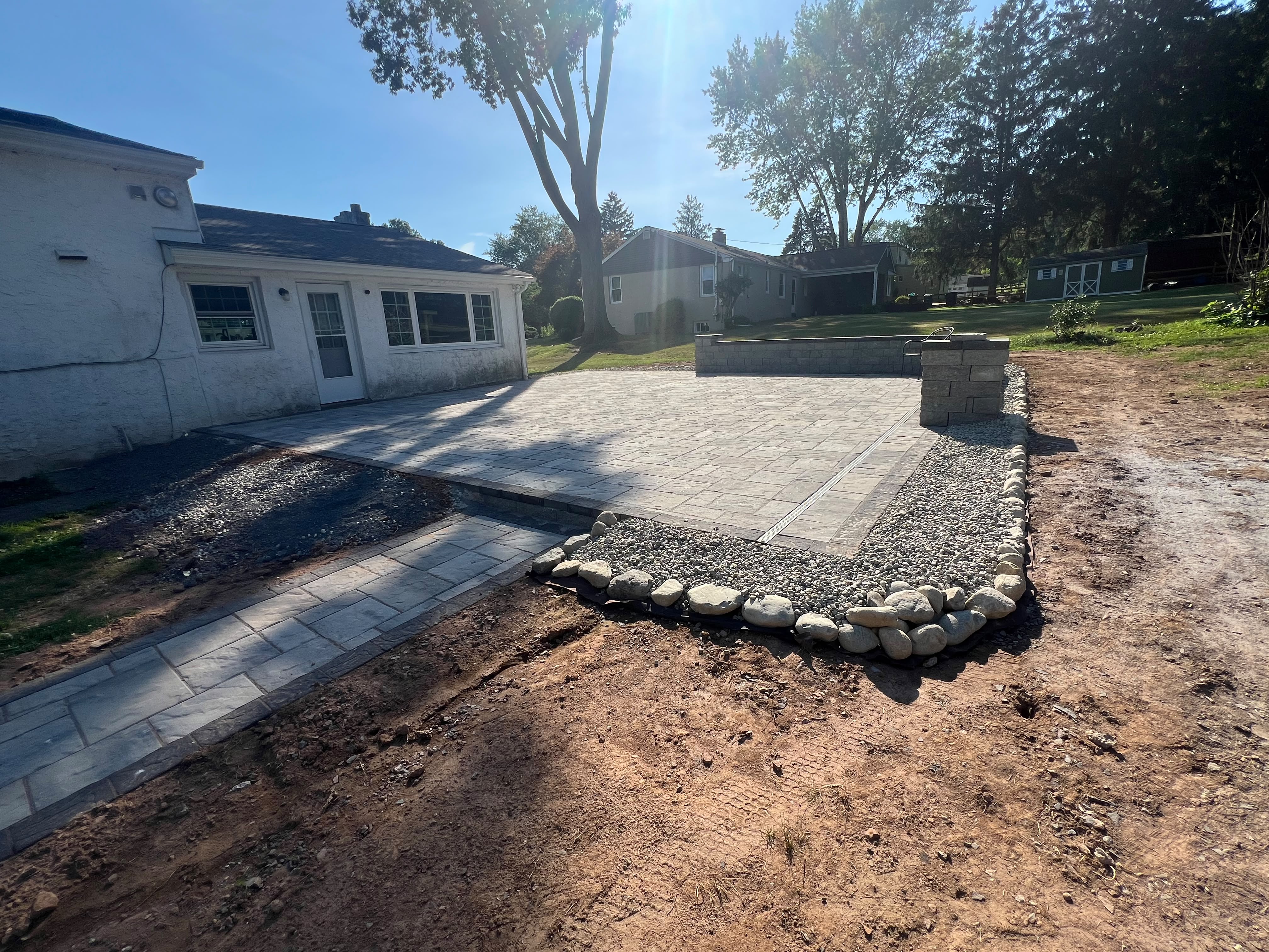 Large paver patio with retaining wall